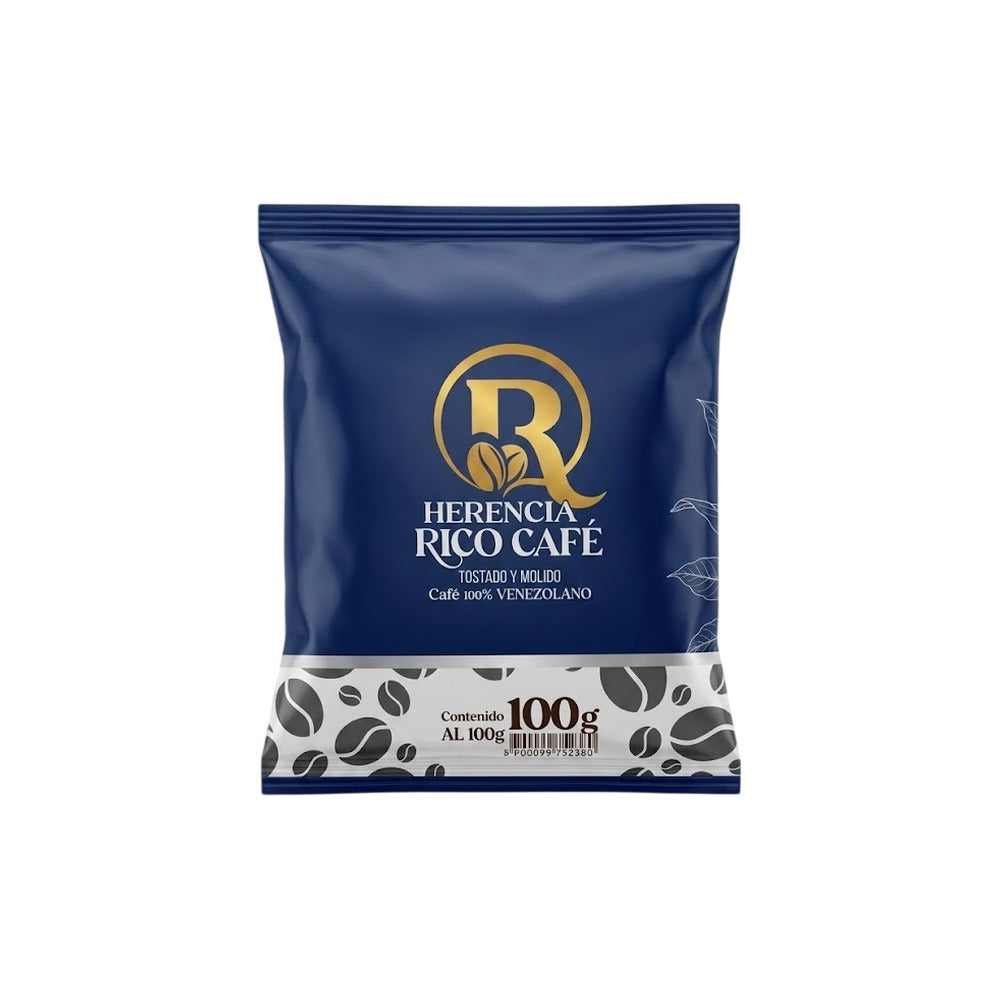 A 100g bag of Herencia Rico Café coffee, featuring a dark blue packaging design with a gold logo and a white patterned bottom section.